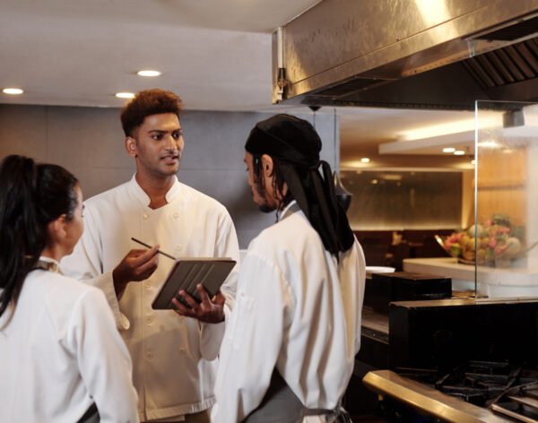 Restaurant chef talking to his team in the beginning of shift